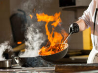 cook making dinner in the kitchen of high-end restaurant